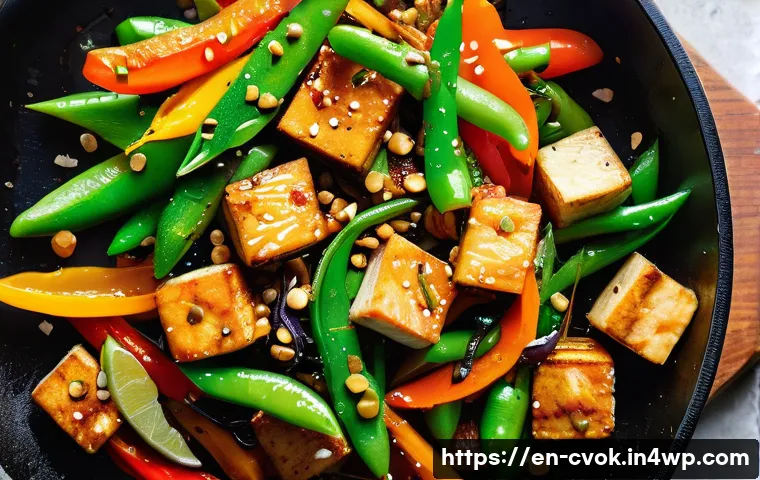 소규모 가정용 대체 단백질 요리 팁 - A vibrant, close-up overhead shot of a colorful one-pan stir-fry featuring cubed tofu pressed and pa...